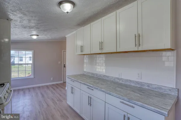 a kitchen with a sink and large window