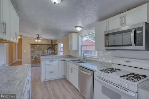 a kitchen with a sink stove and cabinets
