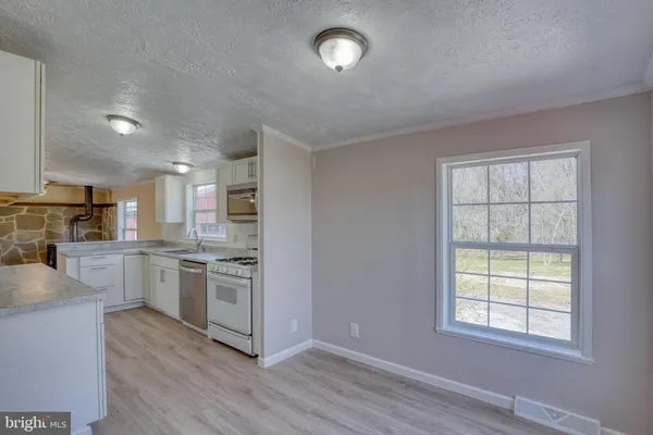 a kitchen with a refrigerator and a stove top oven