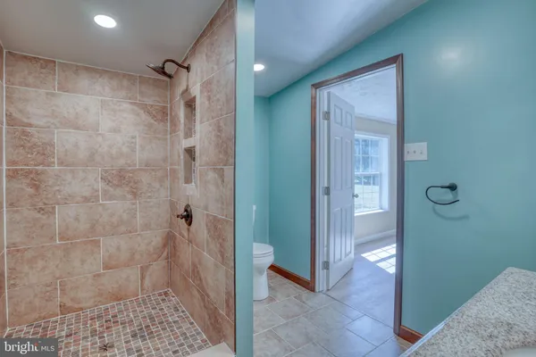a bathroom with a sink toilet tub and shower