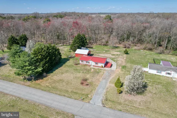 an aerial view of a houses with yard