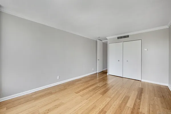 a view of a room with wooden floor and window