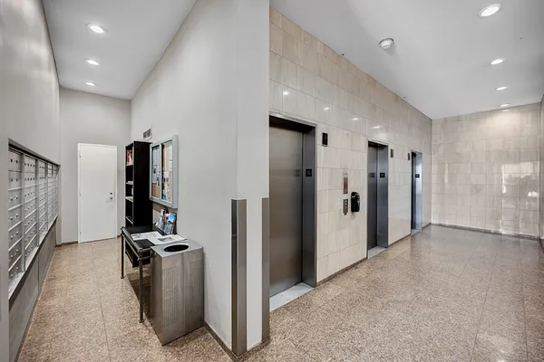 a kitchen with granite countertop a refrigerator a sink a stove a microwave and wooden floor