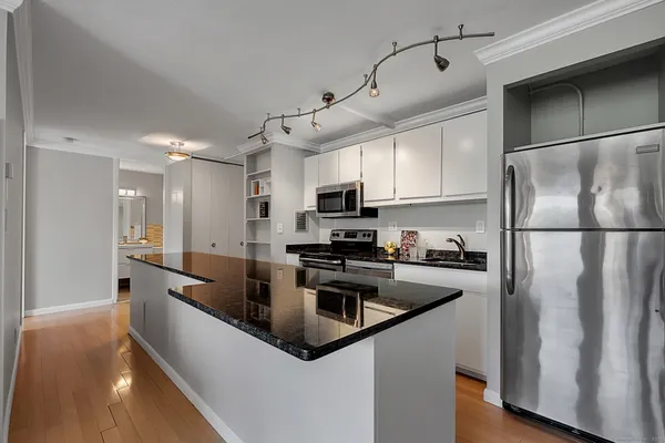 a kitchen with stainless steel appliances granite countertop a stove and a sink