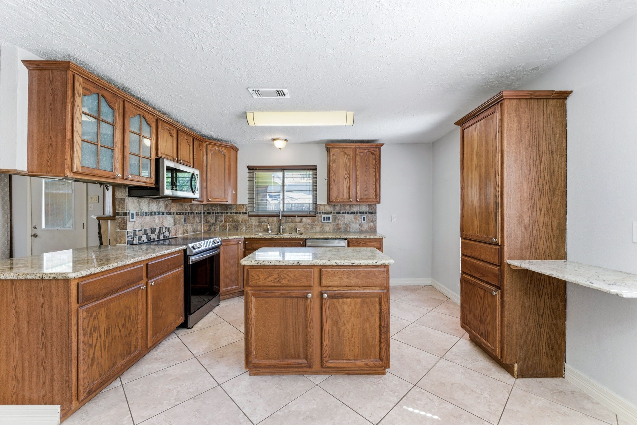 21514 Slippery Creek Lane Spring, TX 77388 - Photo 8 of 27 a kitchen with stainless steel appliances granite countertop a refrigerator and a stove top oven