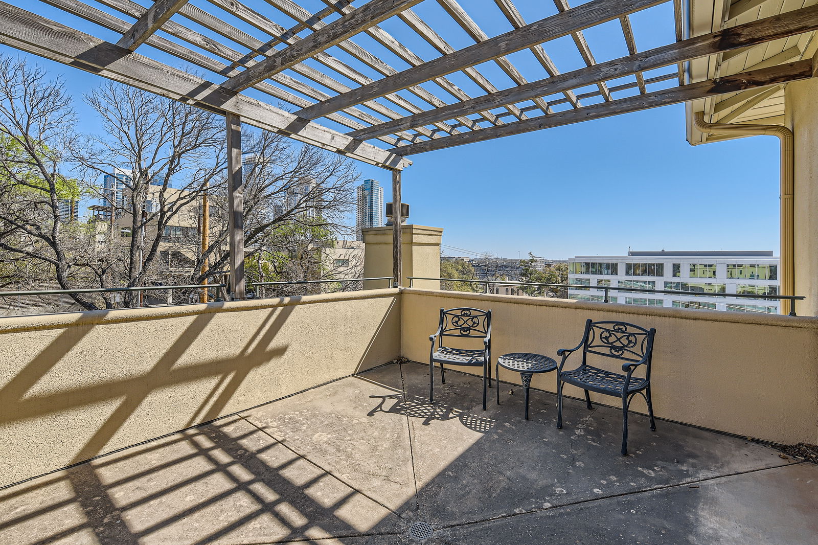 1115 West 7th Street, Unit 202 Austin, TX 78703 - Photo 2 of 12 a view of a balcony with chairs and wooden floor