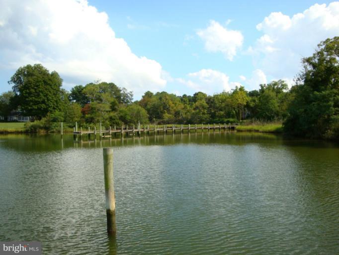 16236 Pine Tree Lane Ridge, MD 20680 - Photo 5 of 30 a view of a lake with houses in the back