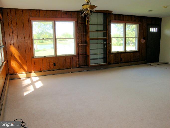 16236 Pine Tree Lane Ridge, MD 20680 - Photo 8 of 30 an empty room with windows