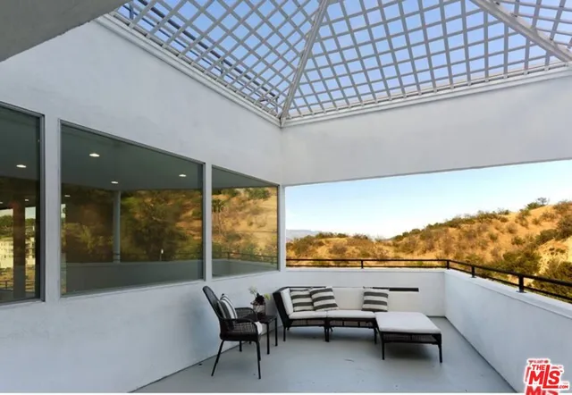 a living room with furniture wooden floor and a table