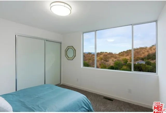a living room with furniture a couch and a bookshelf