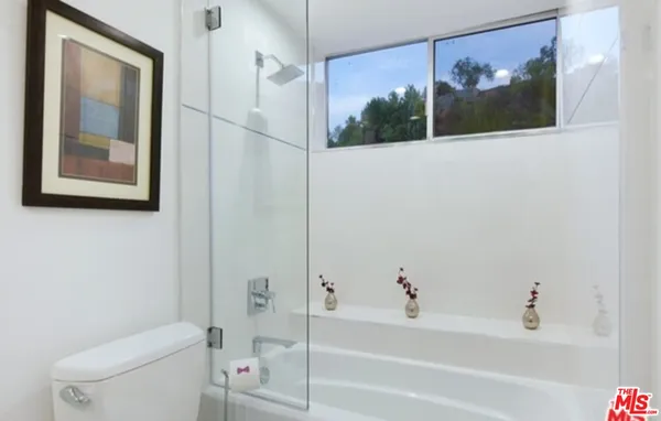 a view of a living room and floor to ceiling window