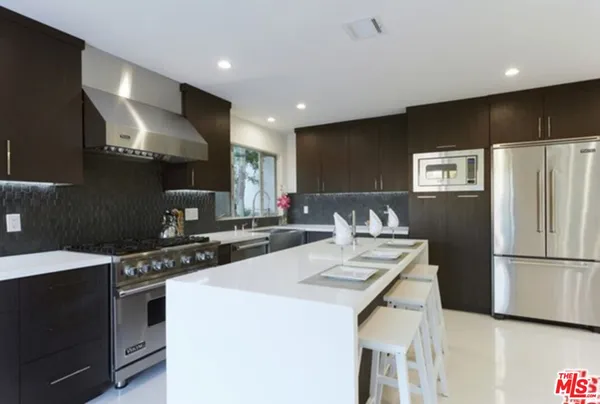 a kitchen with a refrigerator a stove a sink and a refrigerator