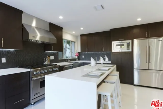 a kitchen with a refrigerator a stove a sink and a refrigerator