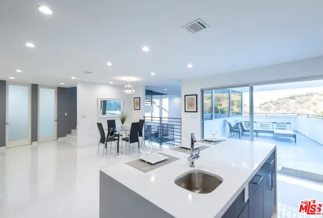 a kitchen with a sink and living room