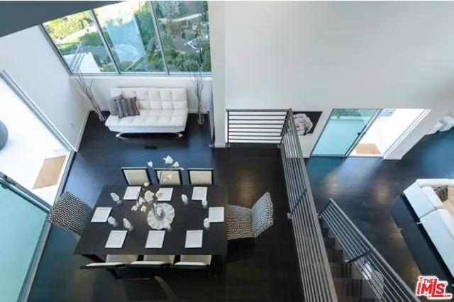 a view of a living room with furniture and wooden floor