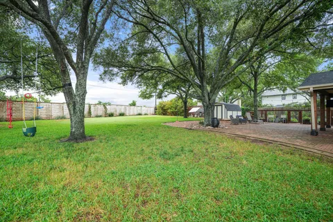 a view of a house with a yard and sitting area