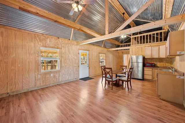 a view of a dining room with furniture and wooden floor