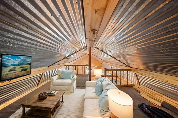 a balcony with wooden floor stairs and a potted plant