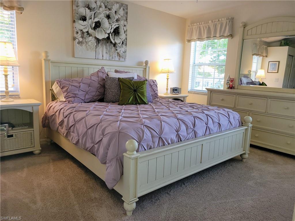 7435 Plumbago Bridge Road, Unit K201 Naples, FL 34109 - Photo 12 of 17 a bedroom with a bed and window