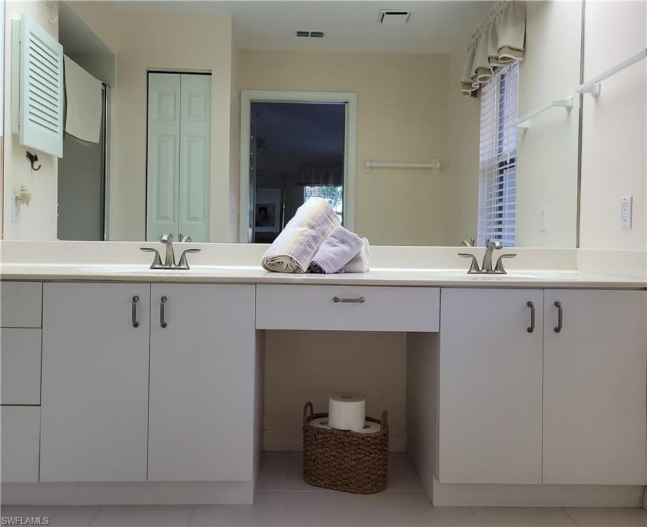 7435 Plumbago Bridge Road, Unit K201 Naples, FL 34109 - Photo 13 of 17 a bathroom with a sink and a mirror