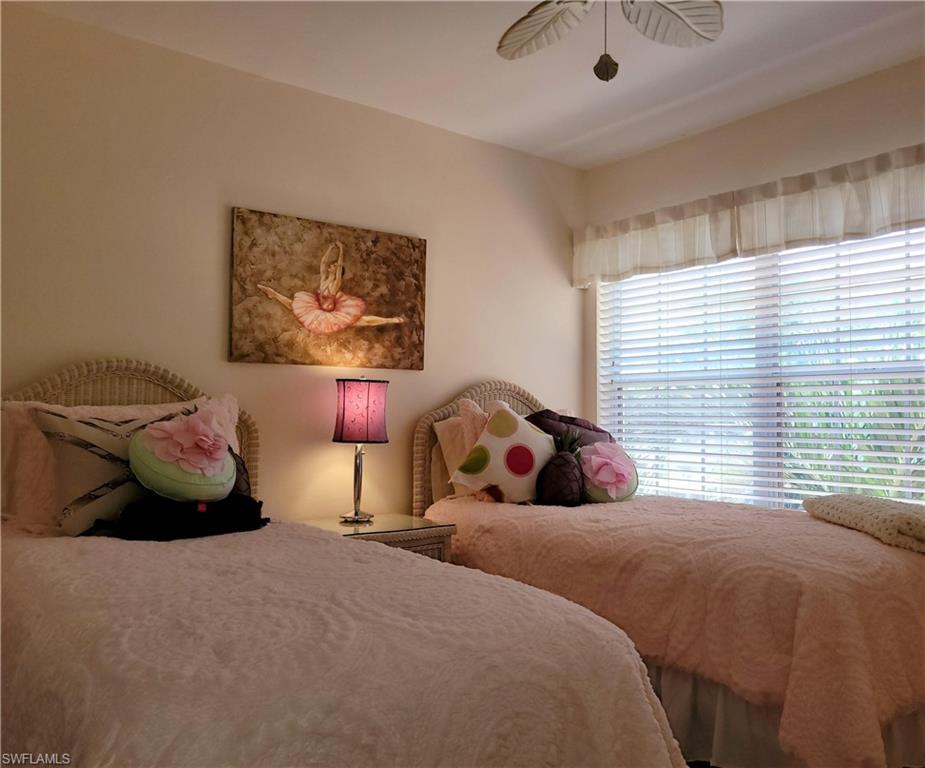 7435 Plumbago Bridge Road, Unit K201 Naples, FL 34109 - Photo 14 of 17 a bed room with a bed and a painting on the wall