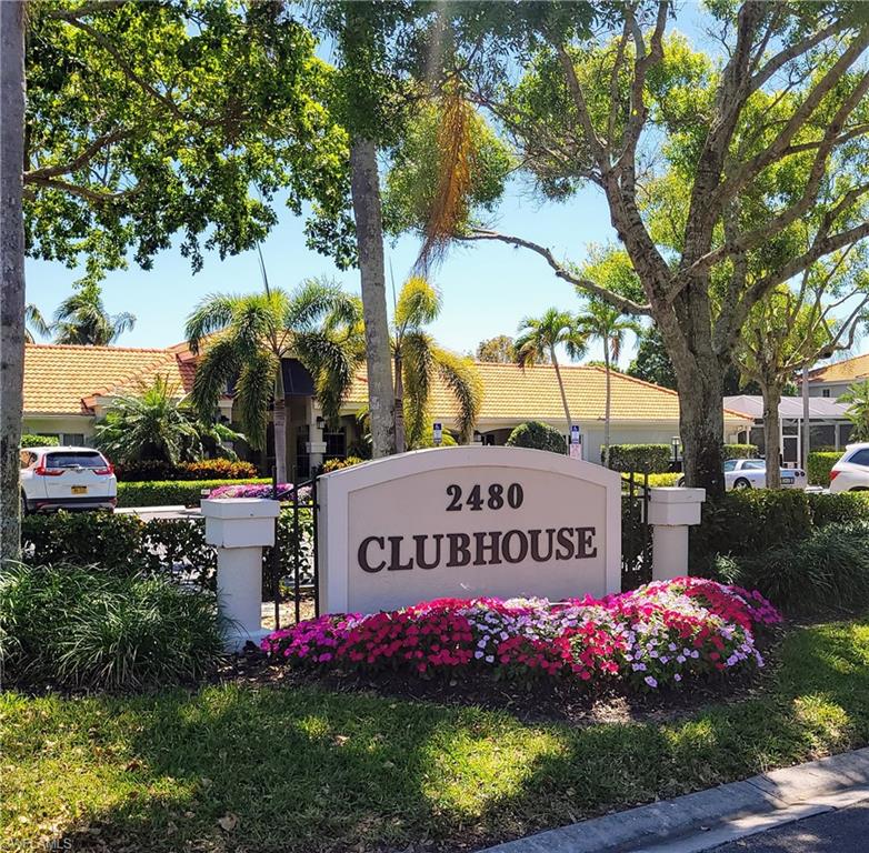 7435 Plumbago Bridge Road, Unit K201 Naples, FL 34109 - Photo 16 of 17 a sign on the side of the road