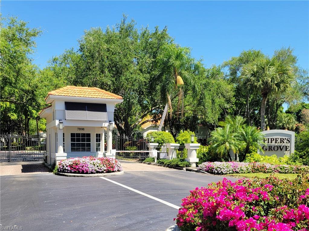 7435 Plumbago Bridge Road, Unit K201 Naples, FL 34109 - Photo 17 of 17 a view of front a house with a yard and a garage