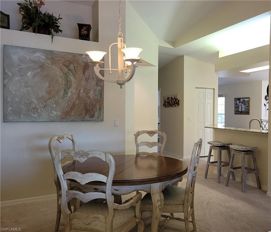7435 Plumbago Bridge Road, Unit K201 Naples, FL 34109 - Photo 7 of 17 a dining room with furniture and wooden floor