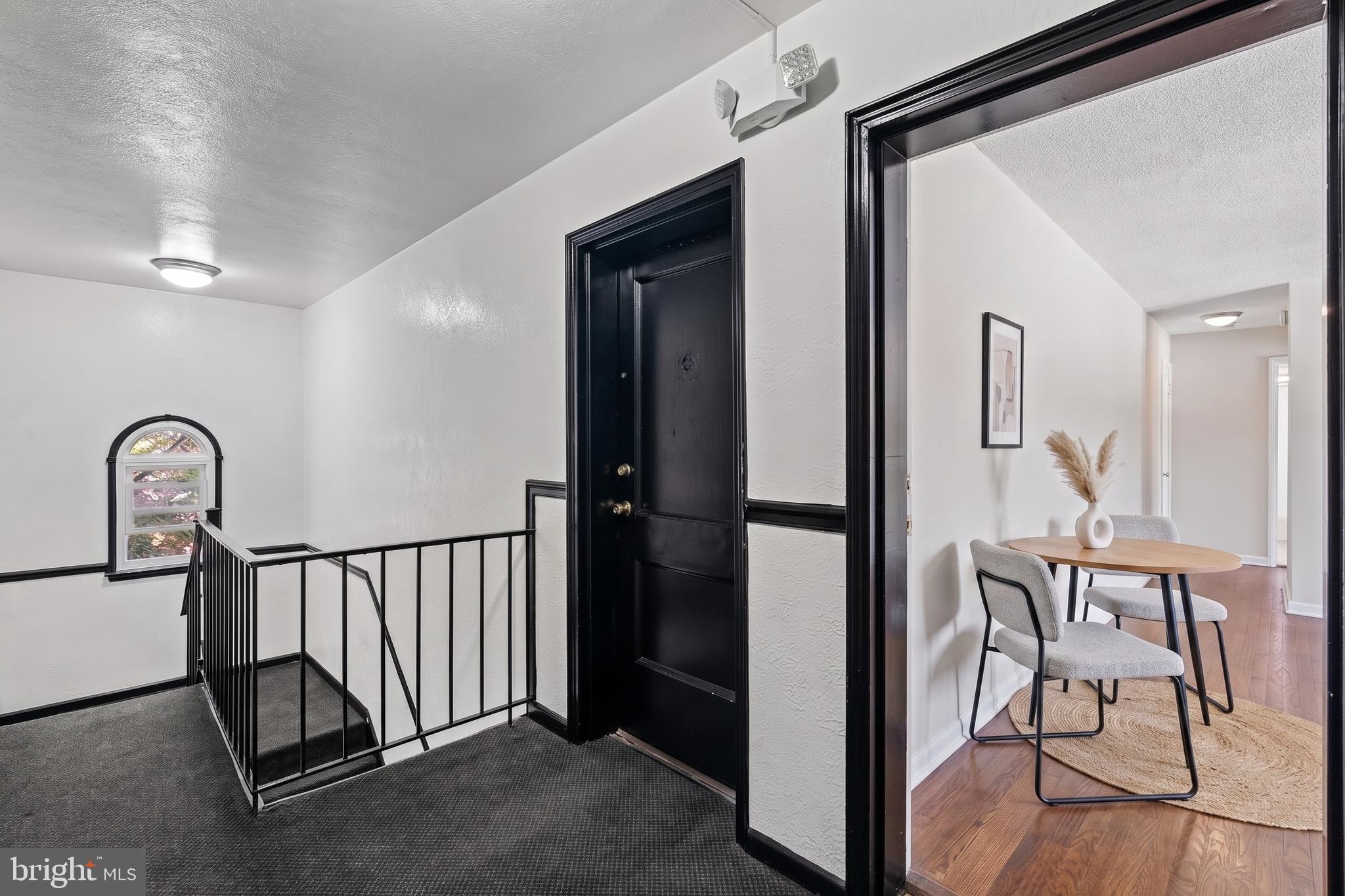 4029 Benton Street Northwest, Unit 302 Washington, DC 20007 - Photo 14 of 27 a view of a hallway and a livingroom with furniture