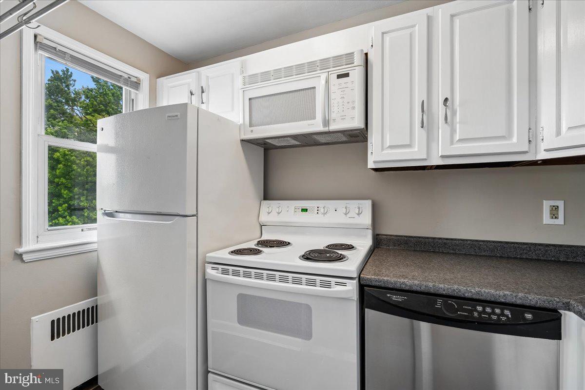 4029 Benton Street Northwest, Unit 302 Washington, DC 20007 - Photo 6 of 27 a white refrigerator freezer and a stove