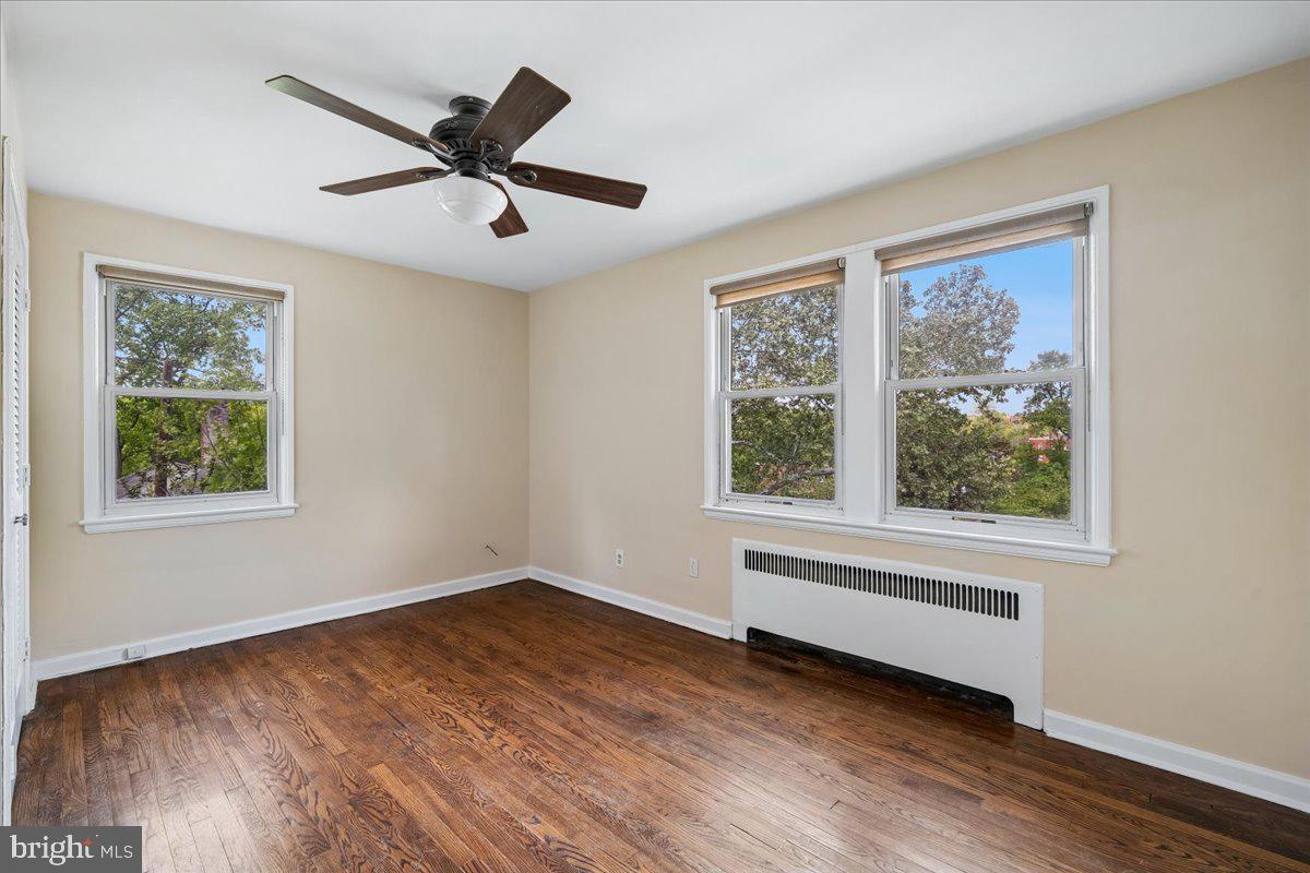 4029 Benton Street Northwest, Unit 302 Washington, DC 20007 - Photo 8 of 27 a view of empty room with wooden floor and fan