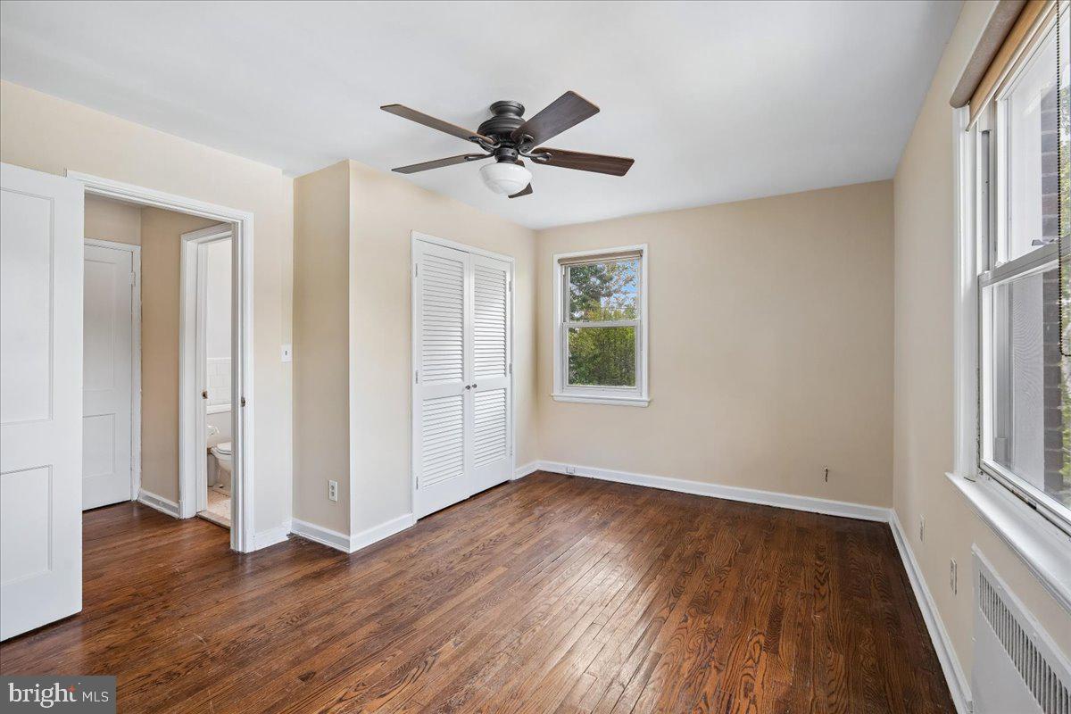 4029 Benton Street Northwest, Unit 302 Washington, DC 20007 - Photo 9 of 27 a view of empty room with wooden floor and fan