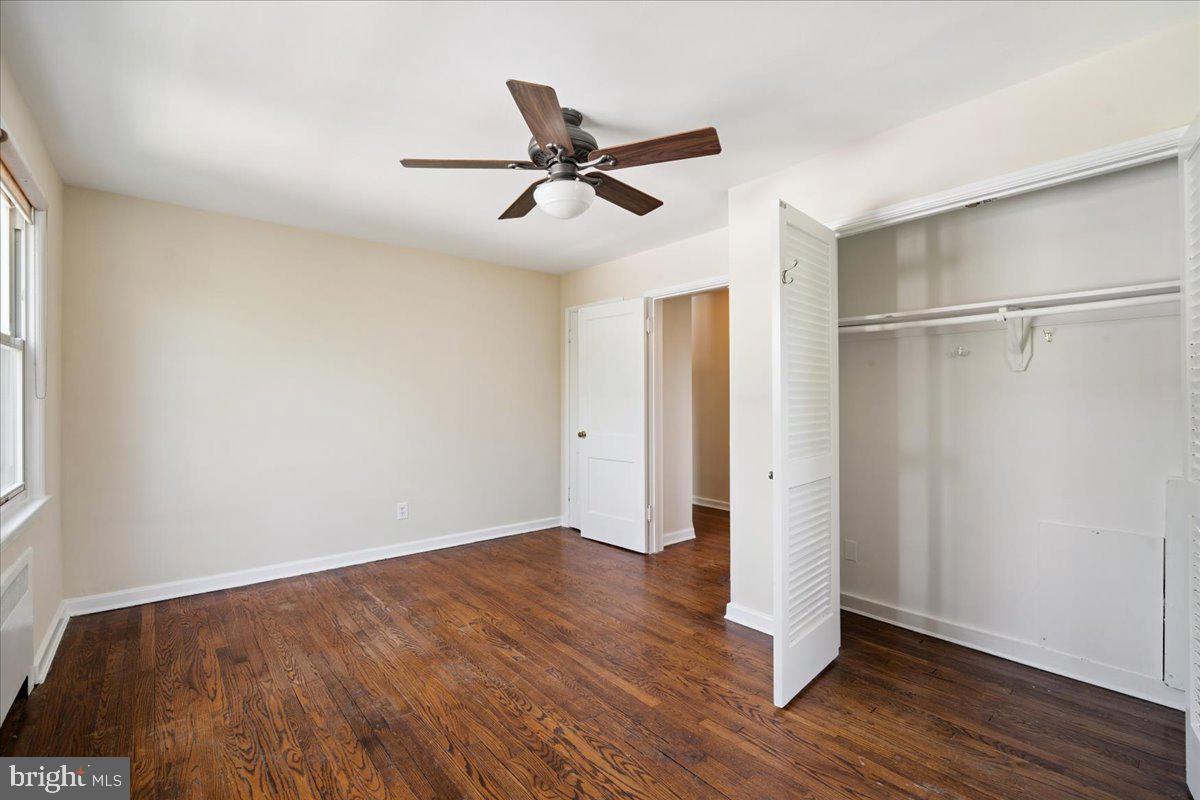 4029 Benton Street Northwest, Unit 302 Washington, DC 20007 - Photo 10 of 27 a view of empty room with wooden floor and fan