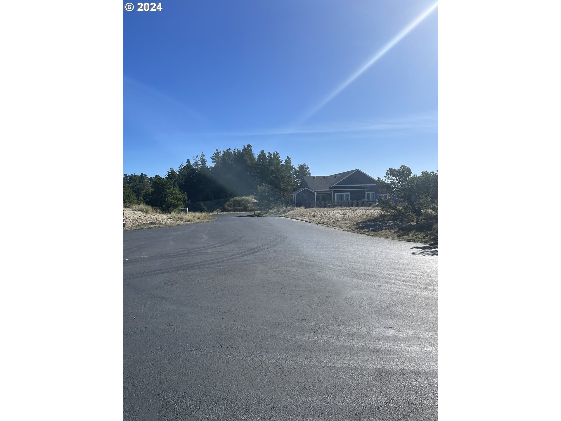 34620 Pinyon Drive, Unit 75 Nehalem, OR 97131 - Photo 3 of 4 a view of a dry yard with a tree