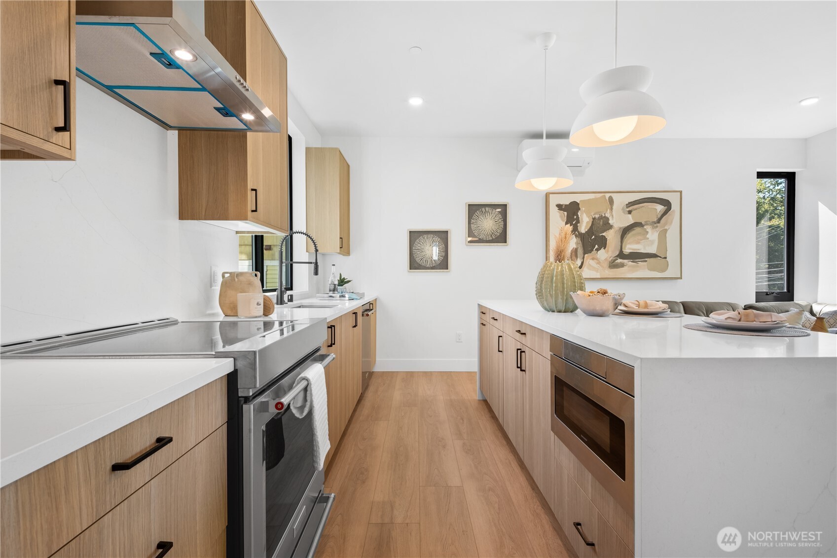 220 21st Avenue East Seattle, WA 98112 - Photo 19 of 38 a spacious kitchen with stainless steel appliances granite countertop a sink and dishwasher a stove with wooden floor