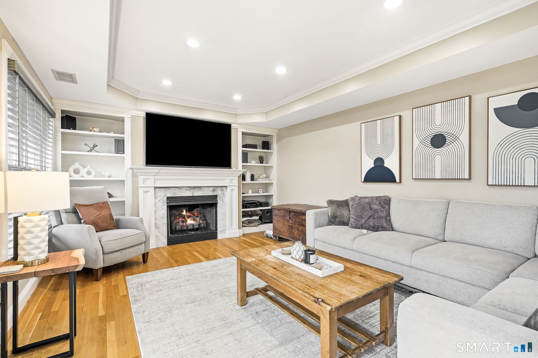 80 3rd Avenue Stratford, CT 06615 - Photo 13 of 40 a living room with furniture a fireplace and a flat screen tv