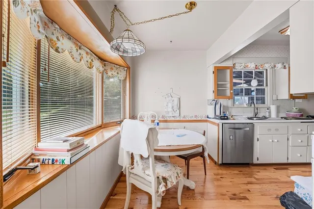 a kitchen with a table chairs stove and cabinets