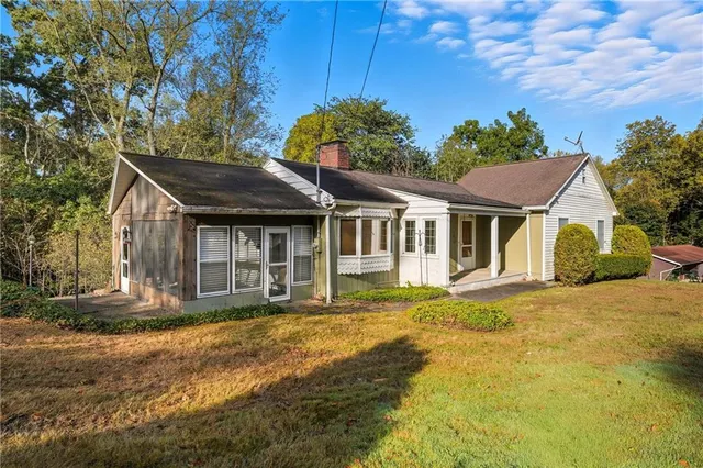 a front view of a house with a garden