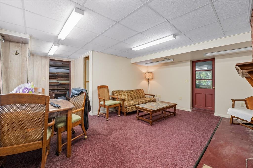 6453 Old Pulaski Road New Wilmington, PA 16142 - Photo 23 of 28 a living room with furniture gym equipment and a window