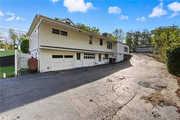 a view of a white house with a yard