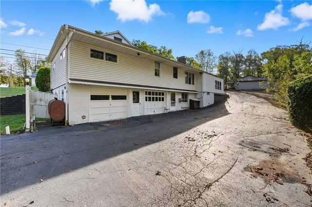 a view of a white house with a yard