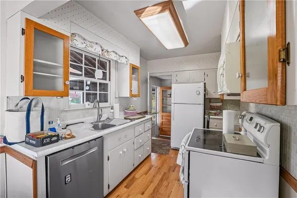 a kitchen with a sink stove and refrigerator