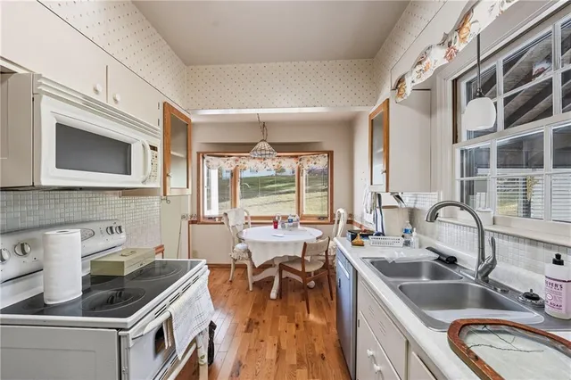 a kitchen with a sink stove and cabinets