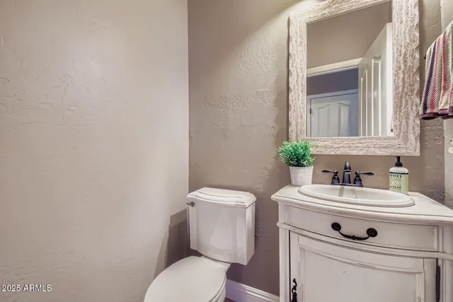 a bathroom with a sink toilet and a mirror
