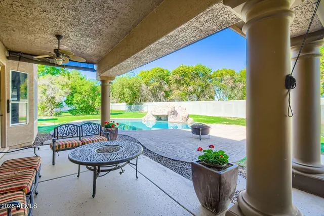 a view of a chairs and table in patio with a yard