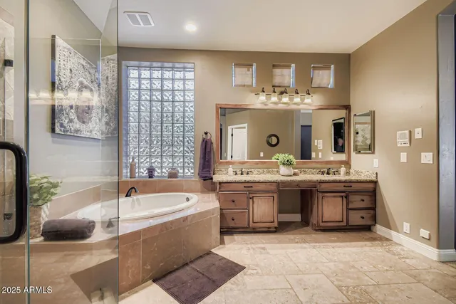 a bathroom with a tub sink and mirror