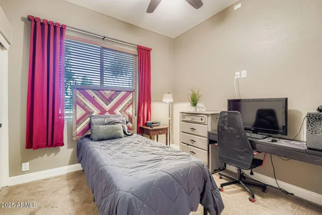a bedroom with a bed and a chandelier