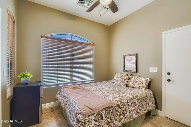 a bedroom with a bed and hallway