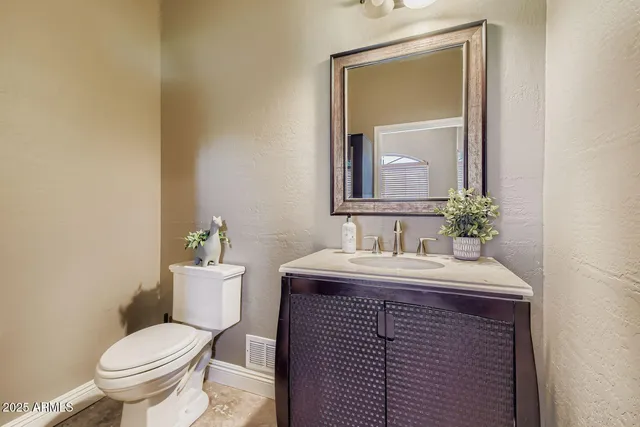 a bathroom with a sink toilet and mirror