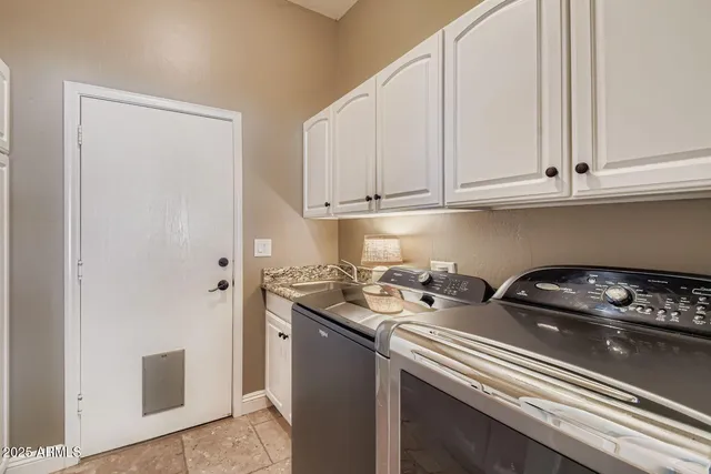 a kitchen with a sink a stove and cabinets
